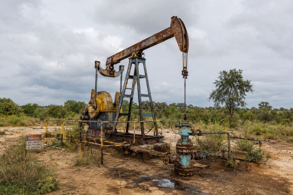 Rusted pumpjack at a marginal field wellhead